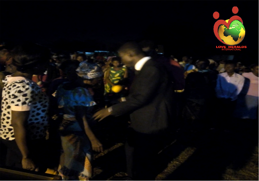 Praying for the sick during Gospel campaign in Togo